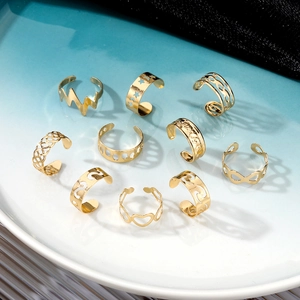 10-piece gold minimalist toe ring set with wave and moon designs in a ceramic dish