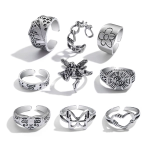 Macro detail of 9-piece vintage silver butterfly and snake ring set with antique finish