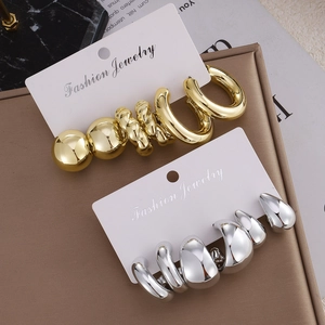 Three-pair set of chunky gold and silver geometric twist earrings on display cards