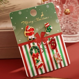 5-piece Christmas enamel brooch set with Santa, wreath, and socks in a gift display
