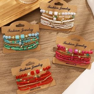 Set of four colorful bohemian multilayered bead bracelets on fashion jewelry display cards