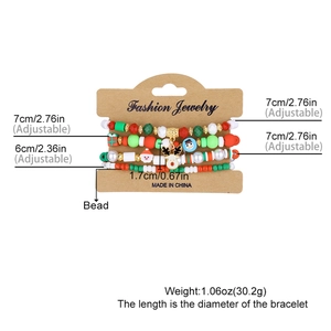 Set of 4 Christmas beaded bracelets with Santa and reindeer charms on white background