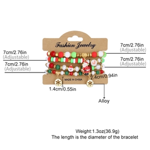 Close-up of 4pcs Christmas beaded bracelets with Santa and snowflake charms on a display card