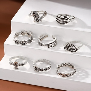 Set of 8 gothic punk rings with skull, eagle, and spider designs in vintage silver finish