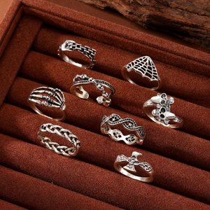 8-piece gothic ring set in vintage silver featuring skull, spider web, and bone designs
