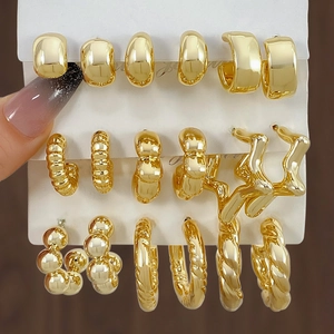 Chic gold-toned earring set featuring twisted textures and smooth hoops on display card