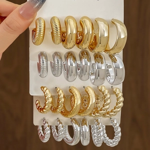 Three-pair gold and silver twisted hoop earring set with textured metallic finishes