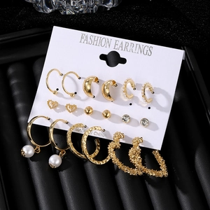 9-piece gold earring set with pearls, hearts and hoops on a premium display card