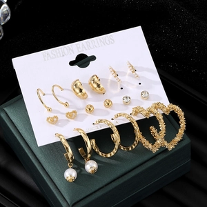 Golden heart earring set with pearls and rhinestones on card, 45-degree close-up view