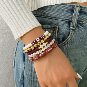 Detail of multi-layer Game Day bracelet set with clay beads and football charm