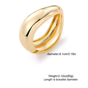 Chunky gold teardrop bangle with hammered texture and polished mirror finish for women