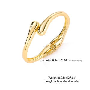 Detail view of golden irregular metal bangle featuring a secure spring hinge and 6.7cm diameter