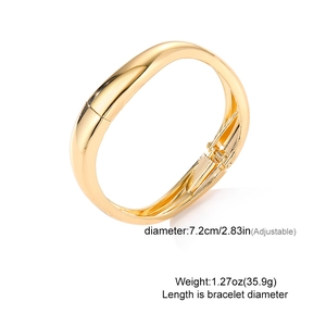 Detail view of gold wide cuff bracelet with adjustable hinge and dimensions shown