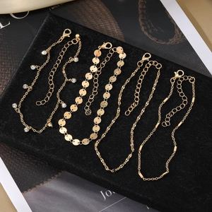 Gouden enkelbandjesset met ster vlinder zirkoon bedels en cubaanse schakelketting