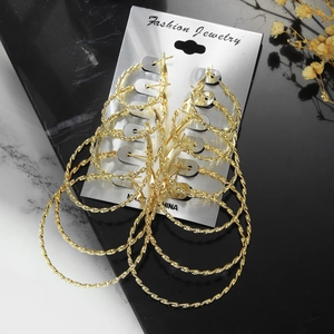 Set of 6 pairs of gold twisted hoop earrings in various sizes on display card