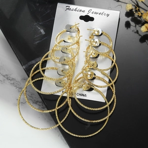 Detailed set of six pairs of gold-colored textured metal hoop earrings on display card