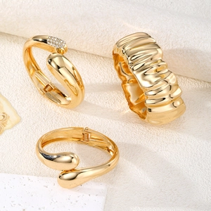 Three-piece gold plated irregular geometric bangle set with liquid metal texture and stones