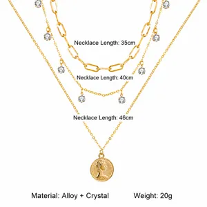 Three-layer gold necklace set with paperclip links, crystals and coin pendant detail