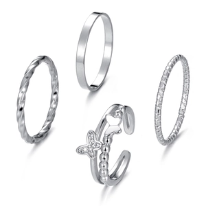 Set of four silver rings with butterfly design and geometric patterns on white background