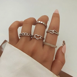 5-piece silver alloy ring set featuring butterfly, heart, and star designs on model hand