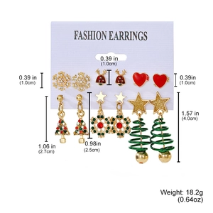 Detailed view of Christmas earring set featuring snowflake and reindeer festive charms