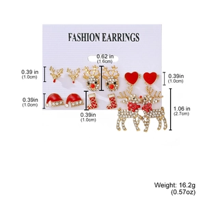 Detail of Christmas earring set with reindeer and Santa charms on display card