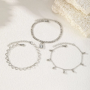 Three-piece silver anklet set featuring padlock pendant, heart links and beaded chains