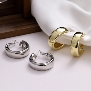 Set of thick gold and silver C-shaped hoop earrings with mirror polished finish