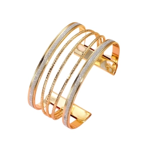 Layered open cuff bracelet with gold-plated geometric waves and frosted glitter texture