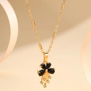 Gold pendant necklace featuring black floral petals with dangling zircon tassels on fine chain
