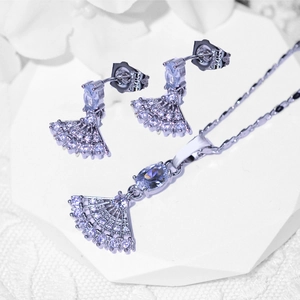 Elegant silver-toned necklace and earrings set with fan-shaped zircon pendants on white stand
