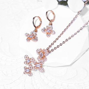 Elegant rose gold butterfly jewelry set featuring a zircon necklace and matching hoop earrings