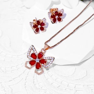 Elegant rose gold butterfly jewelry set with pear-cut red zircon stones and small crystals