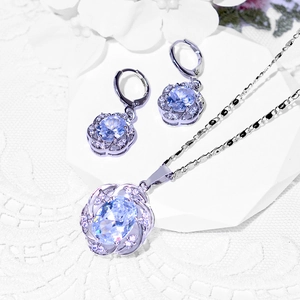 Elegant jewelry set with oval blue zircon pendant and earrings in floral silver settings