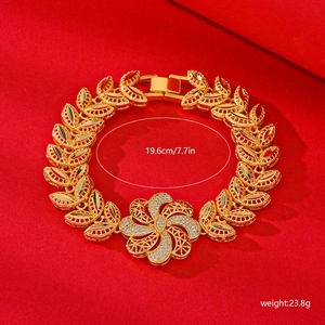 Detail view of a 19.6cm gold leaf link bracelet with flower charm and white zircon stones
