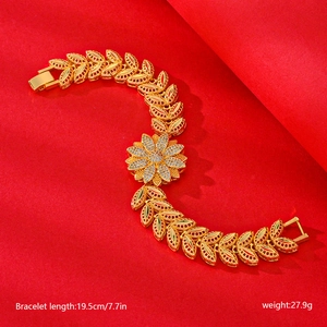 Detailed view of a gold-plated flower bracelet with sparkling zircons and leaf links