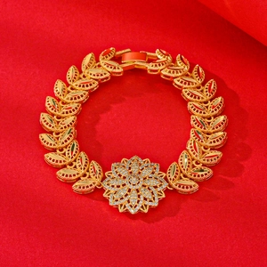Elegant gold plated flower bracelet for women with white zircon stones on red background