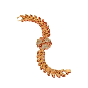 Elegant gold-plated floral bracelet with red enamel and white zircon stones on white background