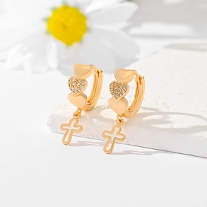 Gold-plated heart and cross drop earrings with zircon inlay on a white stone background