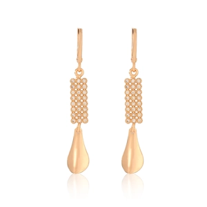 Detailed close-up of rose gold earrings with teardrop pendant and zircon inlay