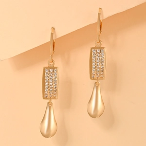 Detailed shot of gold-plated leverback earrings with zircon blocks and smooth water teardrops
