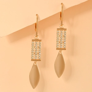 Detail view of gold-plated lever-back earrings with cubic zirconia and leaf drops