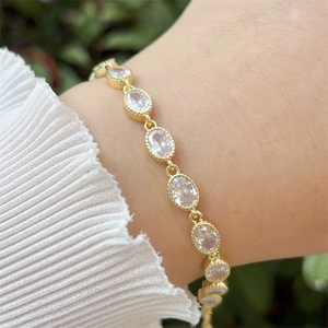 Detailed shot of an adjustable 18k gold plated geometric bracelet with cubic zirconia