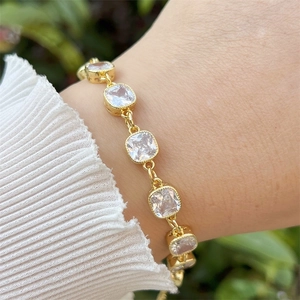Detailed view of 18k gold plated bracelet with square zircons worn on a wrist