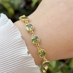 Detail of vintage 18k gold plated brass bracelet with emerald green zircon stones
