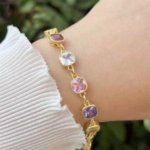 Detail of 18k gold plated geometric bracelet with colorful square cubic zirconia stones