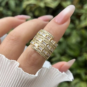 Macro shot of 18K gold plated wide ring with rectangular and round cubic zirconia pavé