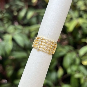 Detailed macro view of multi-layer 18K gold-plated band with shimmering cubic zirconia pavé