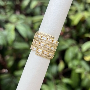 Macro shot of wide 18K gold plated ring featuring multi-row zircon stone settings