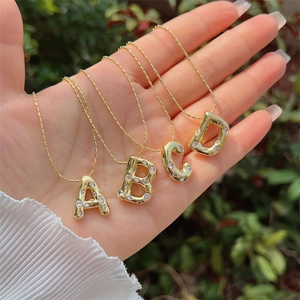 Bubble letter pendant necklace with cubic zirconia in 18K gold plated finish